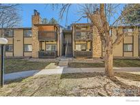 Attractive exterior view showcasing a two-story condo with stone accents and private balconies at 1864 S Pitkin Cir # B, Aurora, CO 80017