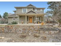 Charming two-story home with covered porch, stone accents, and well-maintained landscaping at 2040 Oak Ave, Boulder, CO 80304