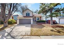 Charming two-story home with a well-maintained front yard and attached two-car garage at 3206 Columbine Ct, Broomfield, CO 80020