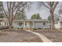 Charming home with gray siding, mature trees, and a welcoming walkway to the front door at 419 22Nd St, Boulder, CO 80302