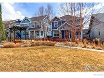 Beautiful blue two-story home with a welcoming front yard and charming pergola in a vibrant neighborhood at 5068 Uinta St, Denver, CO 80238