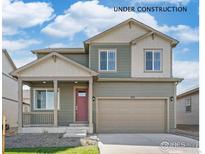 Two-story home featuring a two-car garage, covered porch, and manicured lawn at 6543 13Th St, Frederick, CO 80530