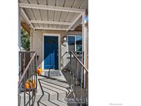 Inviting covered front porch with charming blue door and festive autumn decor at 828 Mariposa St, Denver, CO 80204