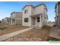 Newly constructed home with modern facade and well-defined walkway leading to covered front entrance at 1051 Spartan Ave, Berthoud, CO 80513