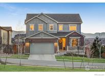Charming two-story home featuring a combination brick and gray siding and manicured front yard at 12917 Fox St, Westminster, CO 80234