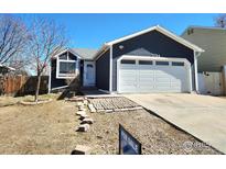 Charming one-story home with a well-maintained lawn and a two-car garage at 1754 Linden St, Longmont, CO 80501