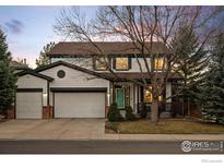 Charming two-story home featuring a two-car garage, a front porch, and a well-maintained lawn at 1808 Southard St, Erie, CO 80516