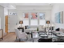 Bright living room features modern decor, large windows, and a glass dining table at 2060 23Rd St # 2, Boulder, CO 80302