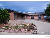 Charming single-story brick home with driveway and an attached garage at 2425 Vassar Dr, Boulder, CO 80305