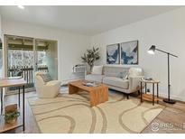 Bright living room featuring a sliding glass door, modern furniture, and stylish decor at 2707 Valmont Rd # 307, Boulder, CO 80304