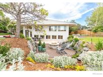Inviting backyard with a fire pit, wood deck, and lovely landscaping, perfect for relaxing outdoors at 3380 Longwood Ave, Boulder, CO 80305