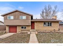 Charming two-story home with brick and wood siding, a well-manicured lawn, and a red front door at 3605 Moorhead Ave, Boulder, CO 80305