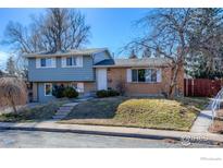 Charming two-story home featuring a brick facade, well-manicured lawn, and a welcoming entrance at 3682 Chase Ct, Boulder, CO 80305