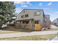 Charming townhome featuring a fenced yard, mature trees, and neutral exterior paint at 4232 Monroe Dr # C, Boulder, CO 80303