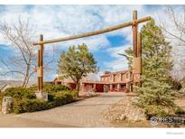 Inviting front entrance to home with an attractive wooden archway and professionally landscaped yard at 4963 Kelso Rd, Boulder, CO 80301