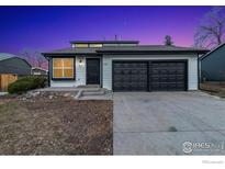 Charming single Gathering home featuring black trim, a spacious driveway, and a well-maintained front yard at 5780 S Parfet St, Littleton, CO 80127