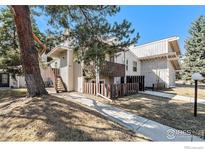 Charming townhouse with a private entrance, lovely wood accents, and mature trees in a well-maintained community at 8060 Niwot Rd # 17E, Niwot, CO 80503