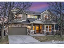 Charming two-story home with stone accents, a two-car garage, and a well-maintained front yard at 1509 Tanager Pl, Longmont, CO 80504