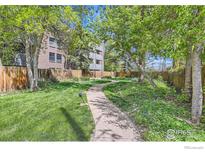 Inviting walkway leading to the building, surrounded by lush greenery and mature trees at 2227 Canyon Blvd # 360, Boulder, CO 80302