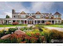 Elegant home featuring a grand entrance, circular driveway, and professionally landscaped flowerbeds at 2300 N 75Th St, Boulder, CO 80301