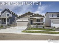 Charming single-Gathering home featuring a two-car garage, stone accents, and a well-maintained lawn at 2711 Crystal Springs Ln, Longmont, CO 80503