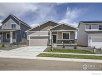 Charming single-Gathering home featuring stone accents, well-manicured lawn, and an attached two-car garage at 2711 Crystal Springs Ln, Longmont, CO 80503