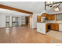 Inviting living room features an open floorplan, fireplace and access to a balcony at 2992 Shadow Creek Dr # 203, Boulder, CO 80303