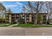 Inviting multi-Gathering property showcasing a well-maintained lawn and private balconies at 400 Emery St # 103, Longmont, CO 80501