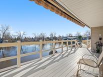 Relaxing covered patio provides serene pond views and a comfortable space to enjoy the outdoors at 43 Scott S Dr, Broomfield, CO 80020