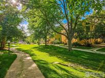 Scenic view of a community with well-maintained lawns, mature trees, and inviting walking paths at 4799 White Rock Cir # D, Boulder, CO 80301