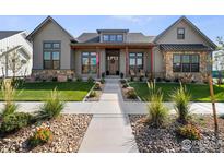 Charming single-Gathering home featuring a beautifully landscaped front yard and inviting entryway at 1315 Burt Ave, Berthoud, CO 80513