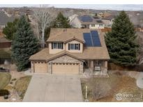 Charming two-story home with a three-car garage, solar panels, and well-maintained landscaping at 13238 Ivy Ct, Thornton, CO 80602