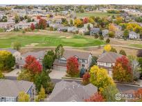 Beautiful aerial view of a home near a golf course with fall colors and neighborhood at 14181 Whitney Cir, Broomfield, CO 80023