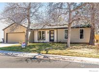 Charming single-story home featuring a well-manicured front lawn and a two-car attached garage at 1420 Fillmore Pl, Louisville, CO 80027