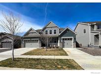 Charming home with a well-manicured lawn, two-car garage and inviting curb appeal at 2407 Tyrrhenian Cir, Longmont, CO 80504