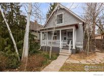Charming gray home with a welcoming front porch and beautifully landscaped front yard at 3056 W 34Th Ave, Denver, CO 80211