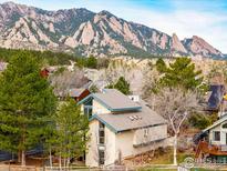 Beautiful home nestled among trees with scenic mountain views in the background at 3075 Galena Way, Boulder, CO 80305
