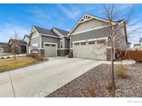 Charming home features a two-car garage, a welcoming entrance, and low maintenance landscaping at 892 Sundown Way, Erie, CO 80516