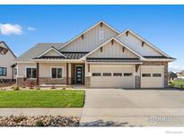 Charming single-story home featuring a two-car garage, well-manicured lawn, and inviting neutral color palette at 1402 Burt Ave, Berthoud, CO 80513