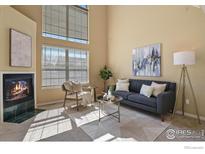 Inviting living room with a fireplace, modern furniture, and lots of natural light at 1747 High Plains Ct, Superior, CO 80027