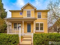 Inviting two-story home with a covered front porch and manicured landscaping at 2946 Shoshone Trl, Lafayette, CO 80026