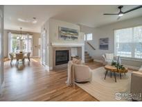 Bright living room featuring a fireplace, hardwood floors, and an open concept layout at 2946 Shoshone Trl, Lafayette, CO 80026