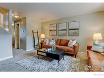 Bright living room with modern decor, neutral walls, and cozy seating area at 1865 Terry St # 3, Longmont, CO 80501