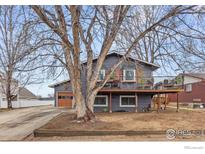Charming home featuring a spacious front yard and inviting wood balcony perfect for outdoor enjoyment at 229 Berwick Ave, Firestone, CO 80520