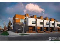 Modern townhome exterior featuring a brick facade, wood accents, and a rooftop deck at 2304 Pearl St # 2, Boulder, CO 80302