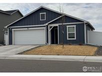 Charming single-story home with a blue exterior, white trim, and a two-car garage at 401 Bonneville Ave, Fort Lupton, CO 80621