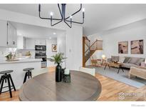Inviting living room featuring hardwood floors, a gray sofa, and a modern chandelier at 4248 Corriente Pl, Boulder, CO 80301