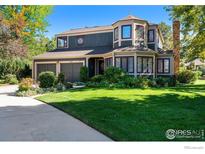 Charming two-story home with well-manicured lawn, mature trees, and a two car garage at 6850 Frying Pan Rd, Boulder, CO 80301