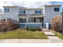 Charming townhome with well-maintained lawn and inviting entrance, perfect for a cozy living experience at 1419 Red Mountain Dr # 15, Longmont, CO 80504