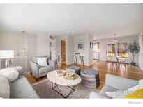 Bright living room featuring hardwood floors, and neutral decor at 1529 Ashcroft Dr, Longmont, CO 80501